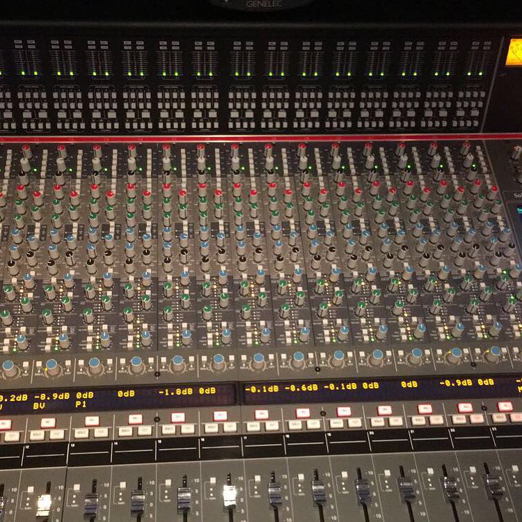 Channel strips and level meters across a large-format analog studio console
