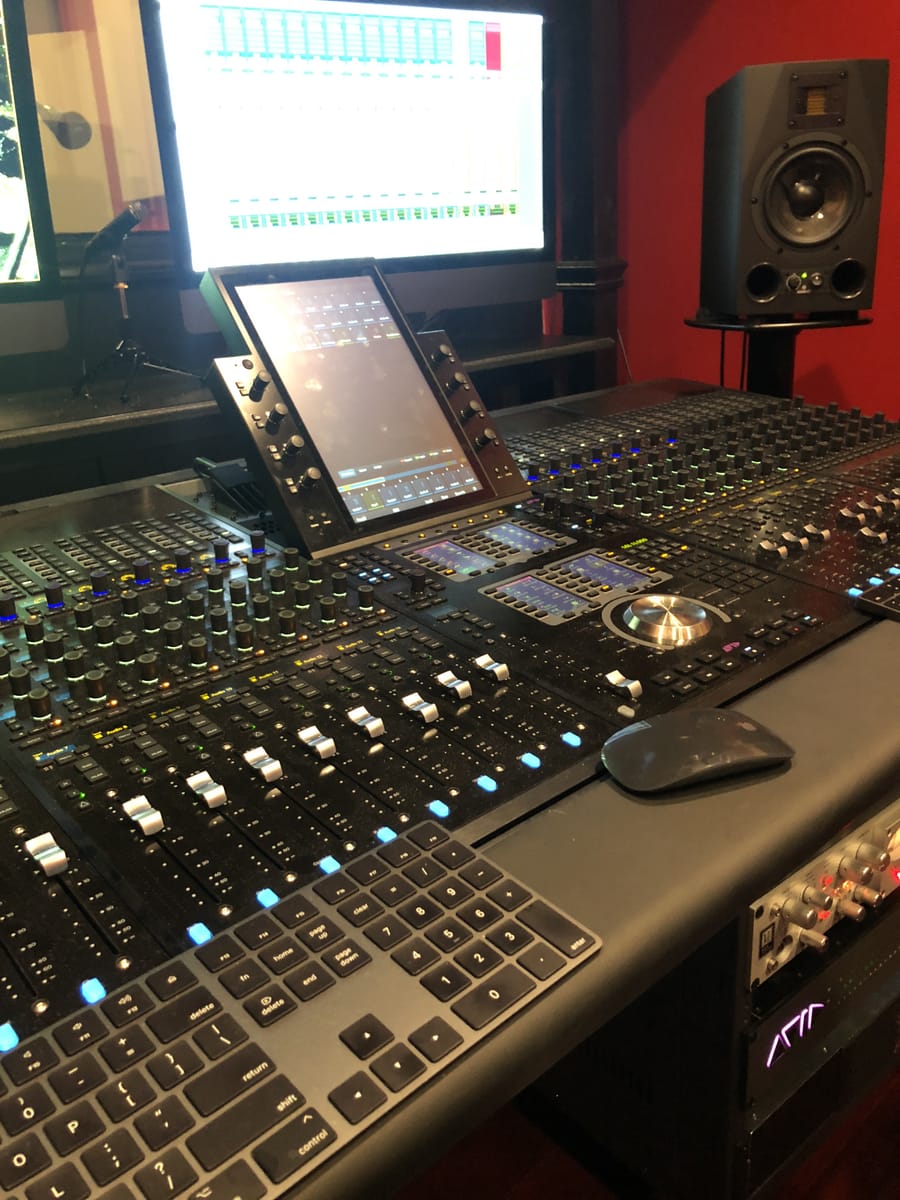 Solidus79's mixing console and DAW setup, with dual monitors showing an active session